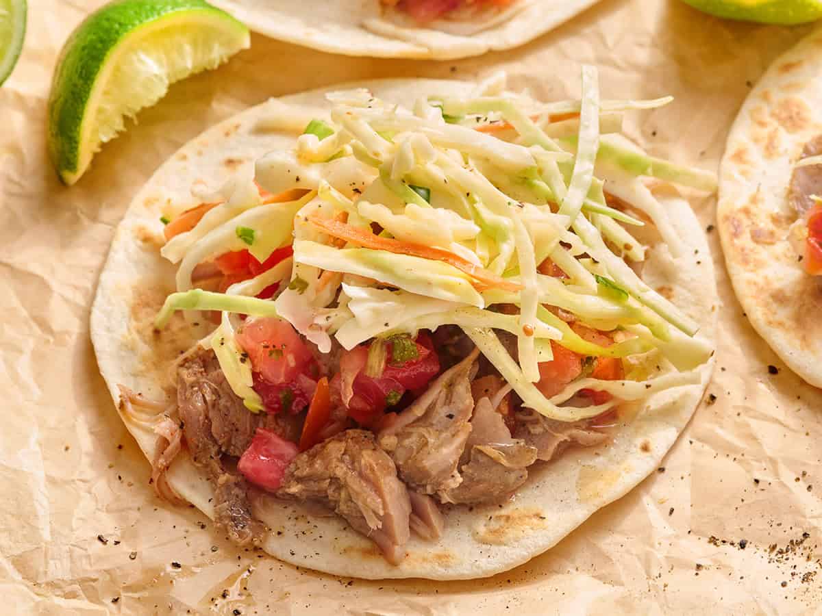 Front view of creamy coleslaw on a pork taco.