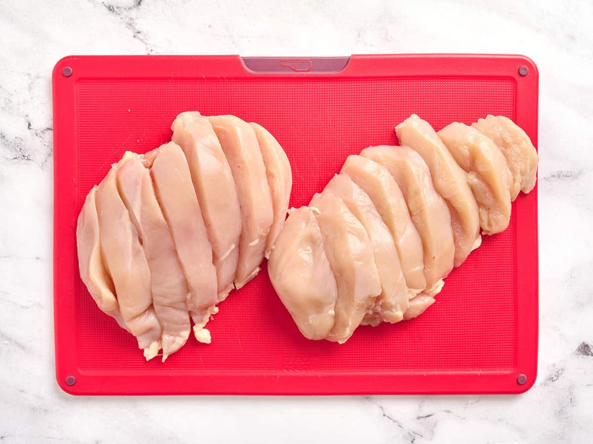 Two chicken breasts cut into slices.