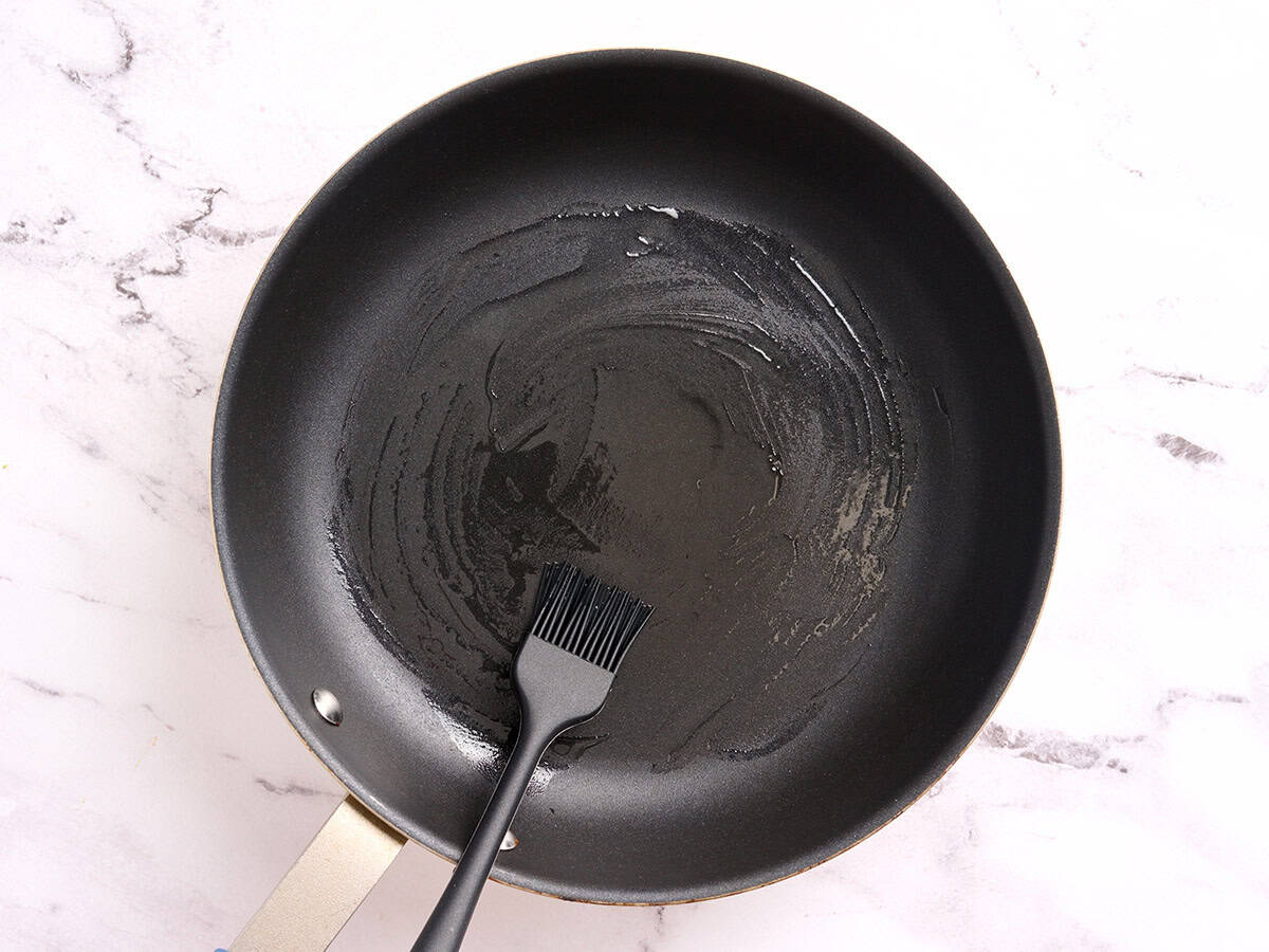 Oil being brushed on a hot skillet.