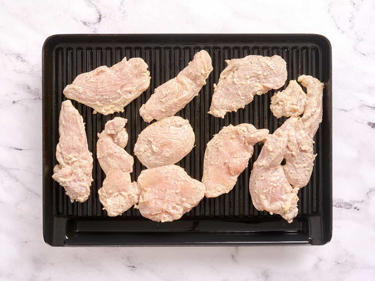 Chicken Shawarma cooking on a grill.
