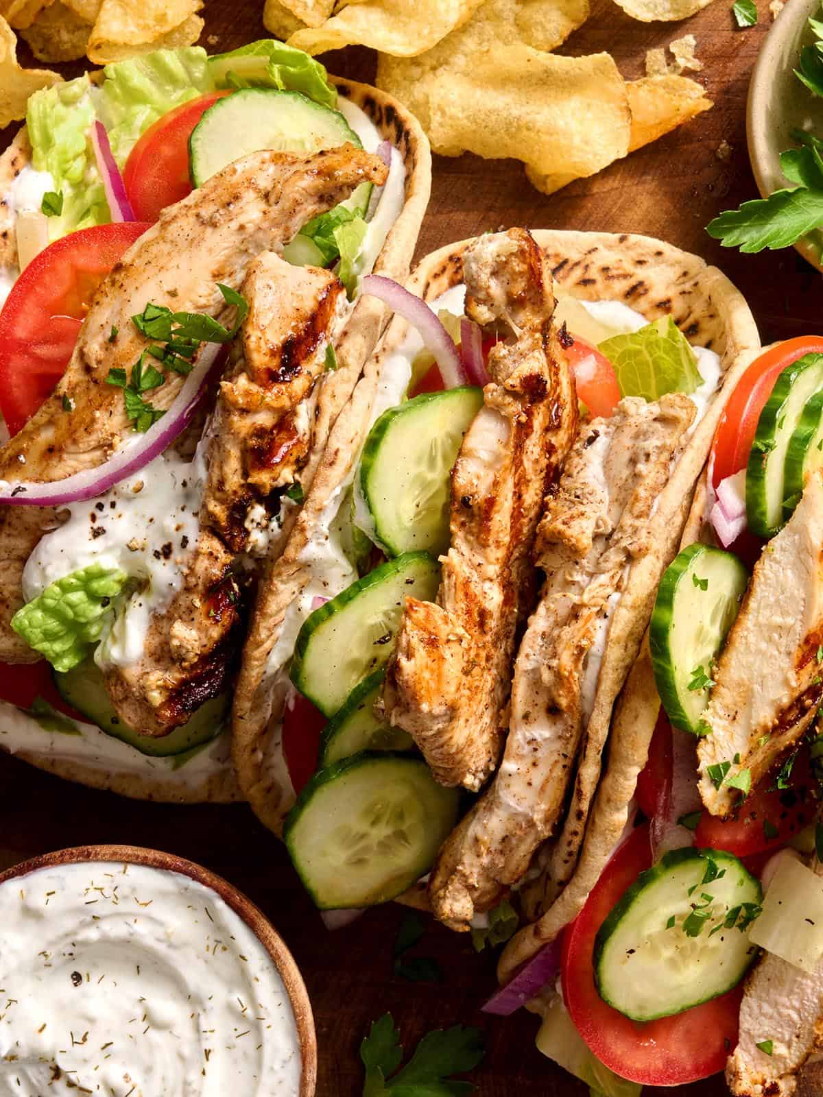 A magical blend of yogurt, lemon, and mediterranean spices makes this homemade chicken shawarma mouthwateringly delicious. Step by step photos. Overhead of chicken shawarma in a pita.