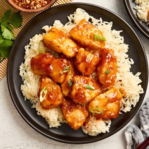 Overhead view of firecracker chicken on a bed of rice.
