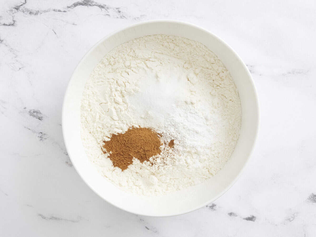 Flour, cinnamon, and baking powder in a bowl.