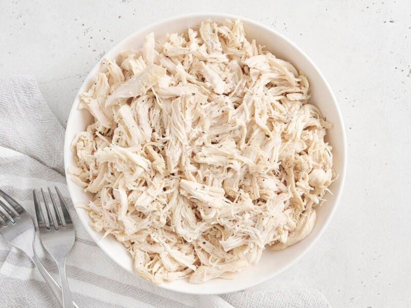 Overhead view of a bowl of pulled chicken.