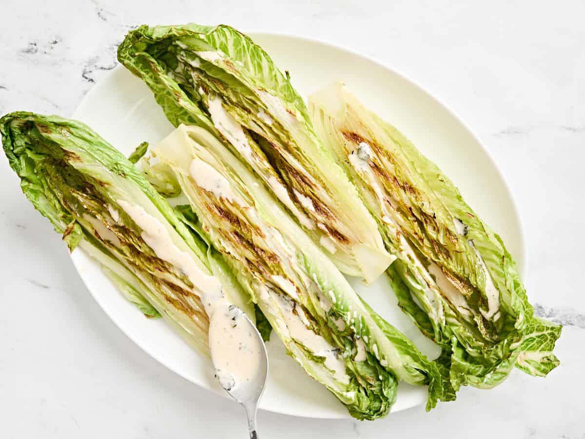 Grilled romaine caesar salad on a serving platter.