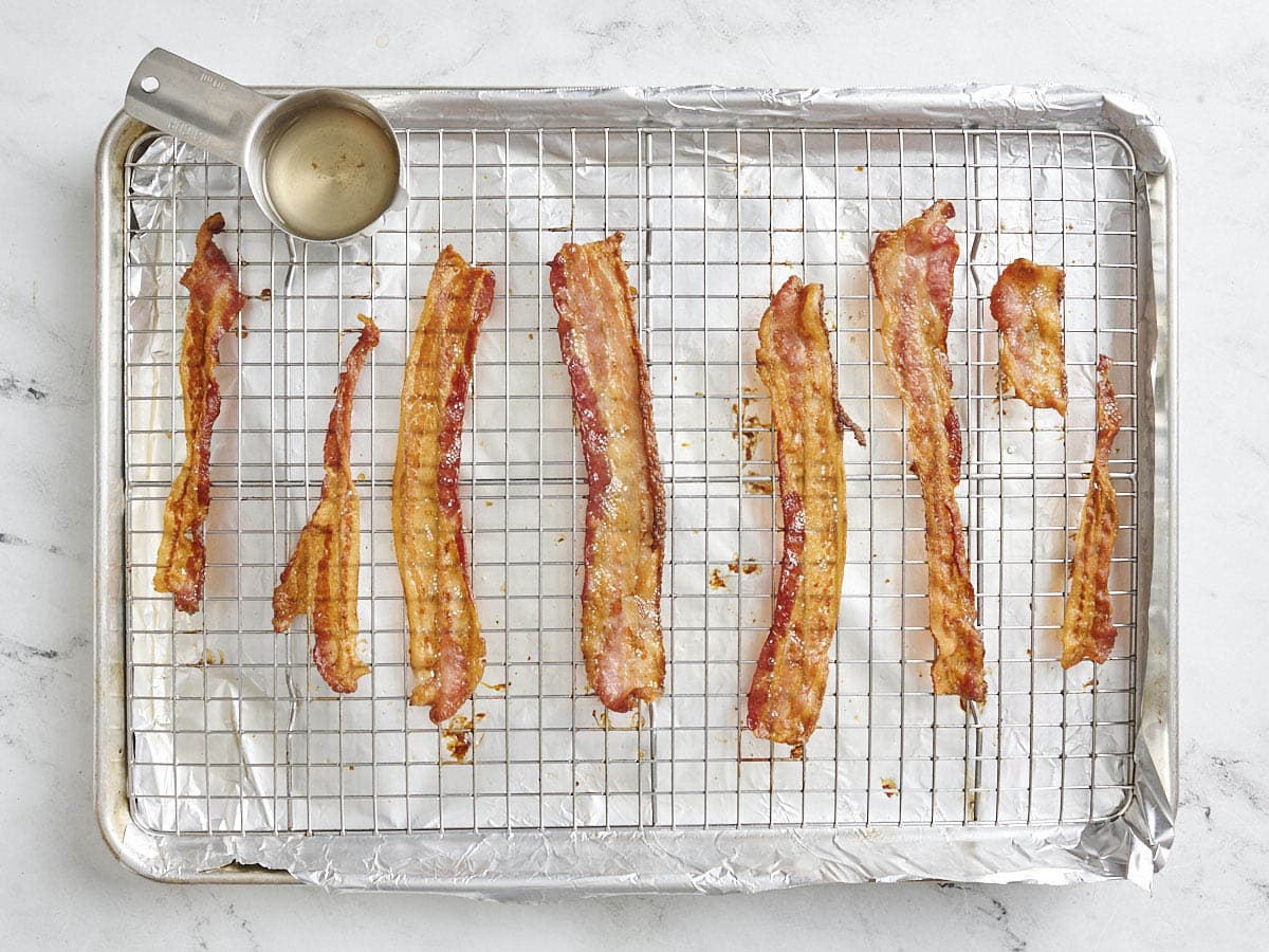 Cooked bacon on a baking sheet.