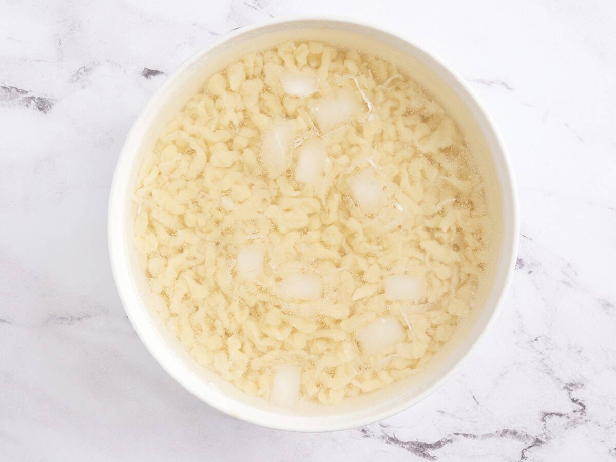 Homemade Spaetzle in an ice bath,