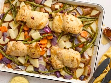 Overhead view of sheet pan honey mustard chicken with veggies.