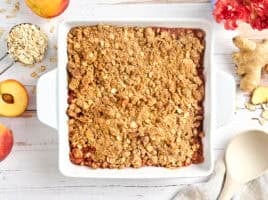 Overhead view of a peach crisp in a baking dish.