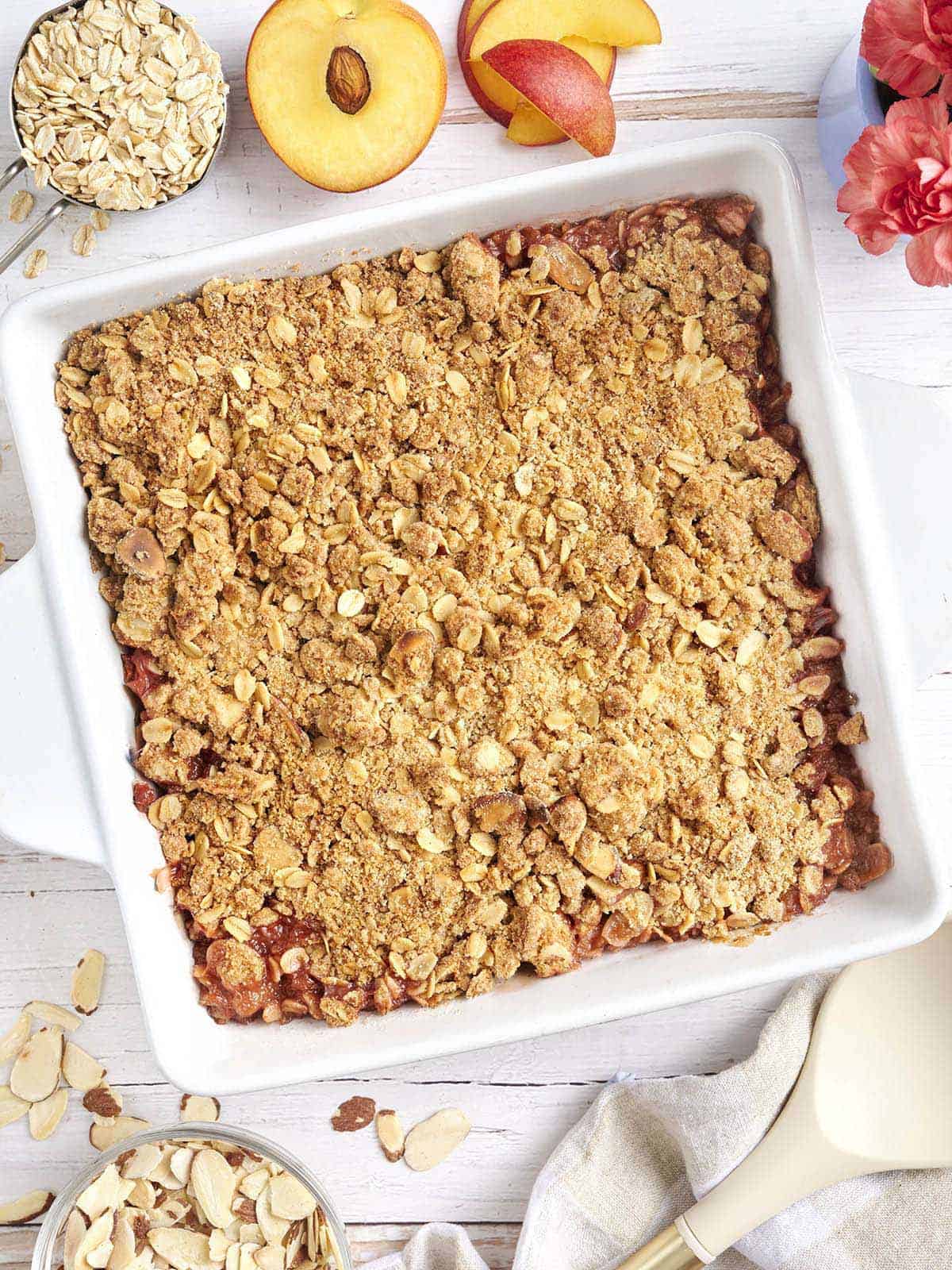 Overhead view of a homemade peach crisp in a baking dish.