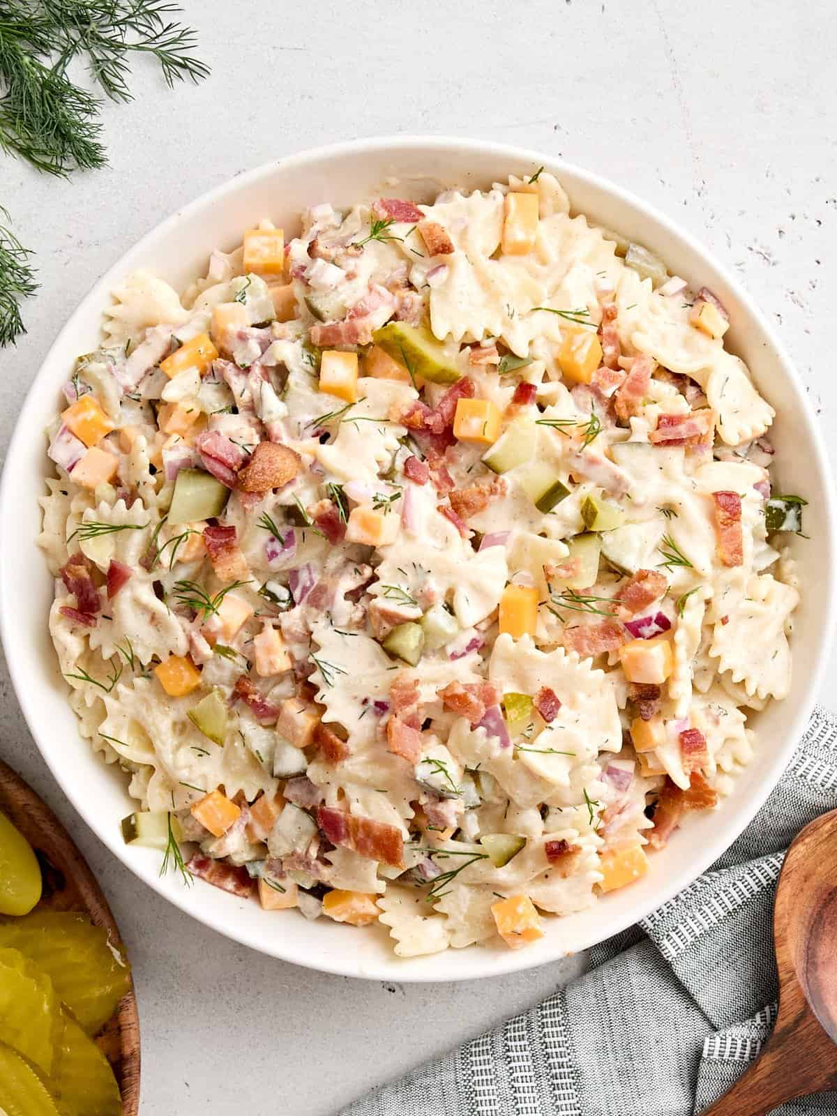 Overhead view of a bowl of dill pickle pasta salad in a bowl.