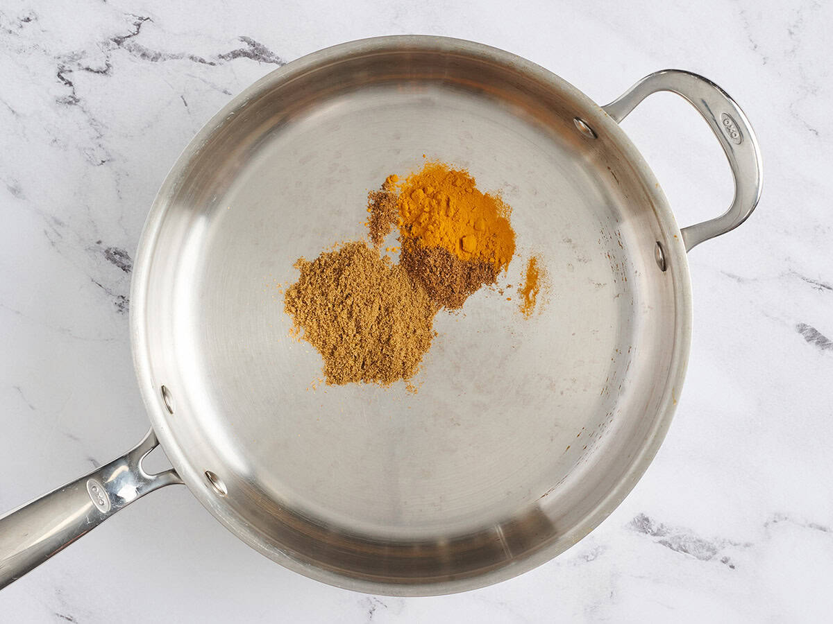 Dried spices in a skillet.