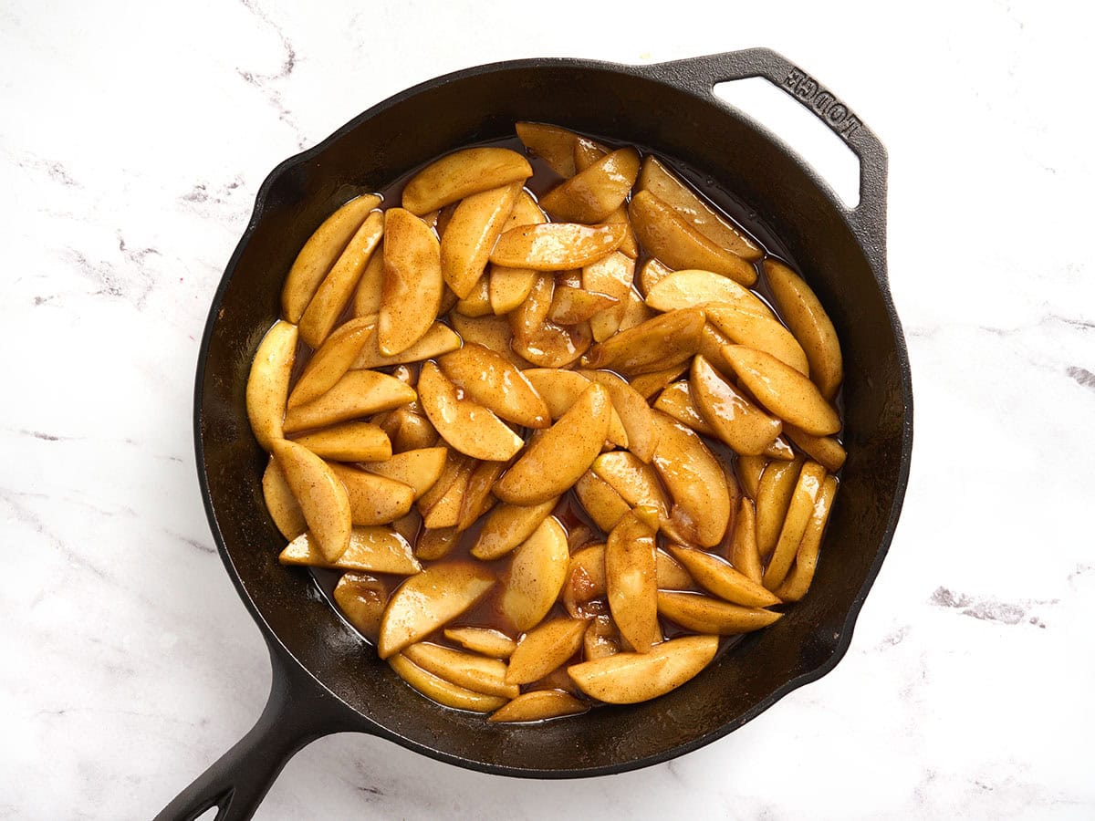 Overhead view of a skillet filled with fried apples.