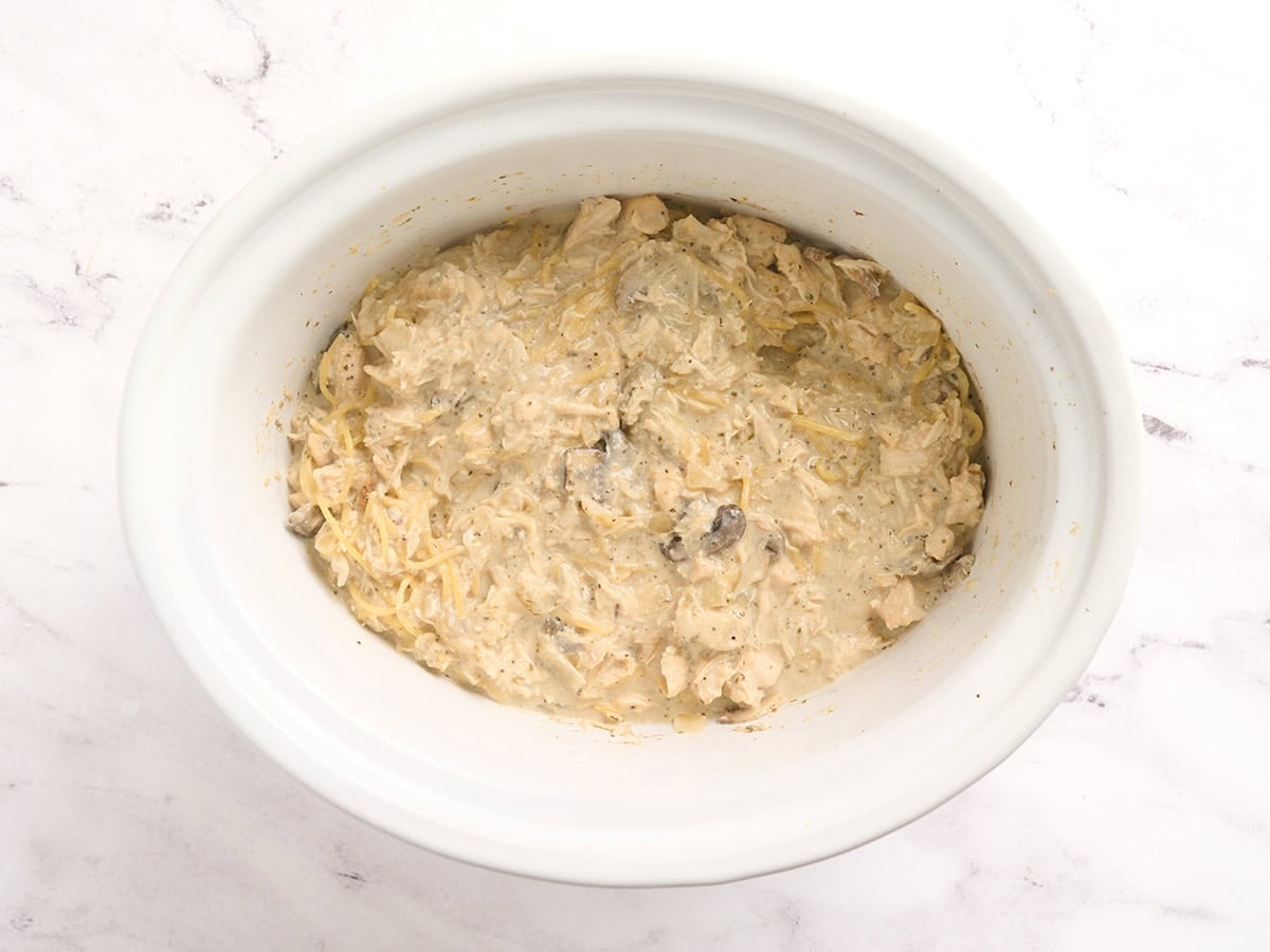 Chicken tetrazzini in a crockpot with cream cheese stirred through.