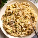 Overhead view of a plate of crockpot chicken tetrazzini with a fork.