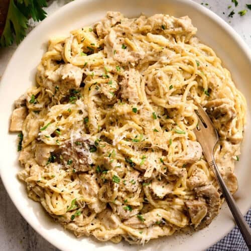 Overhead view of a plate of crockpot chicken tetrazzini with a fork.