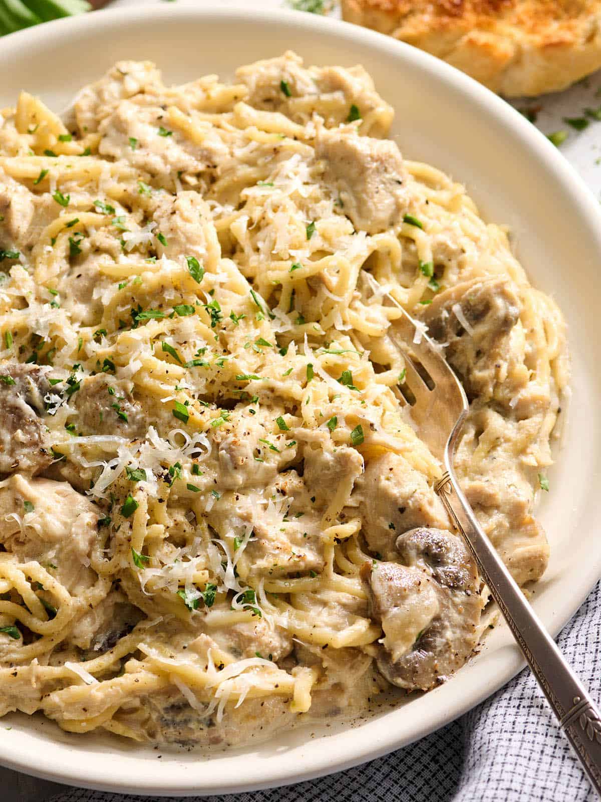 Overhead view of a plate of crockpot chicken tetrazzini with a fork.