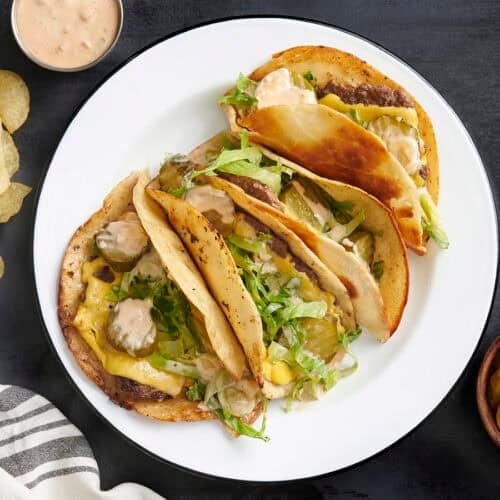 Overhead view of a plate of homemade smash burger tacos.