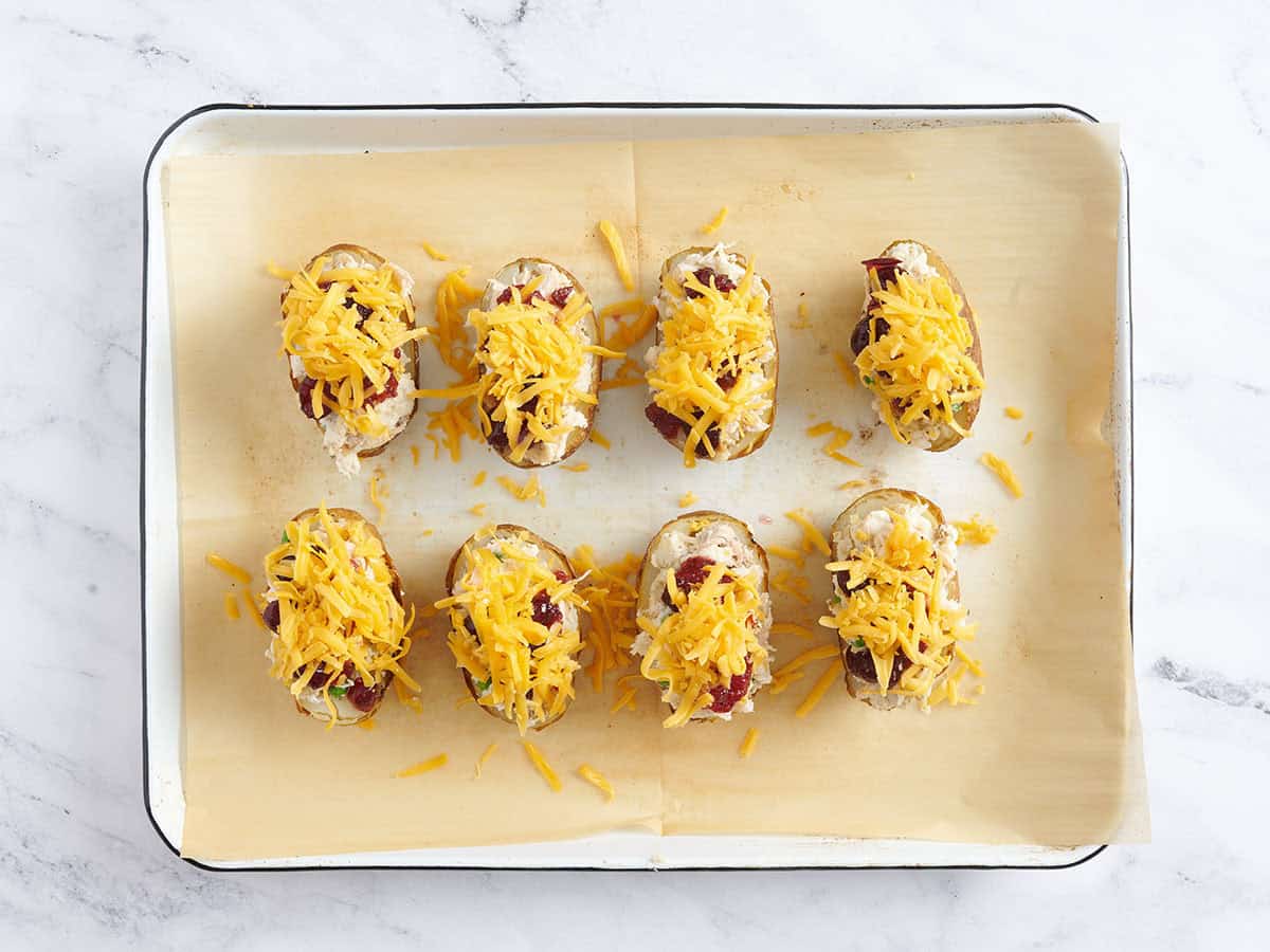 Cheese added to thanksgiving potato skins.