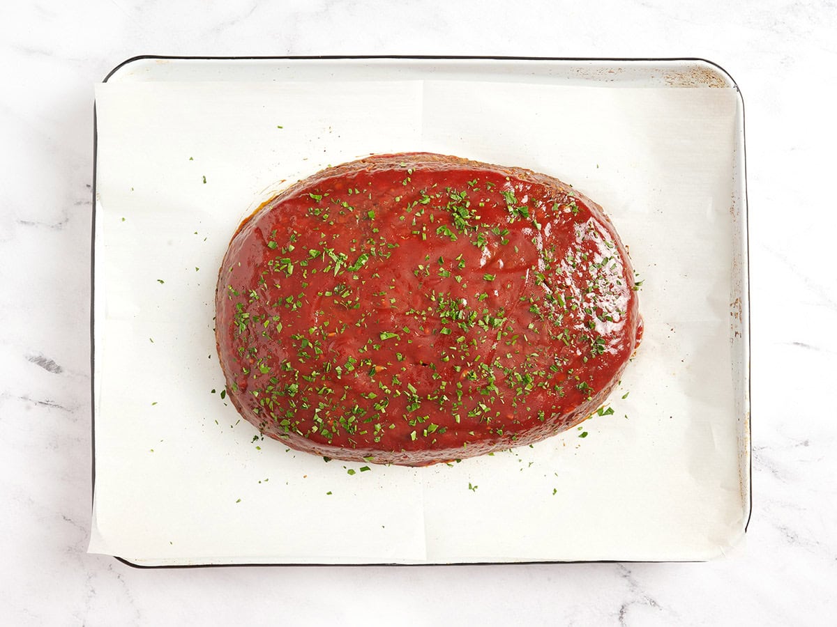 A finished lentil loaf on a parchment lined baking sheet after baking.