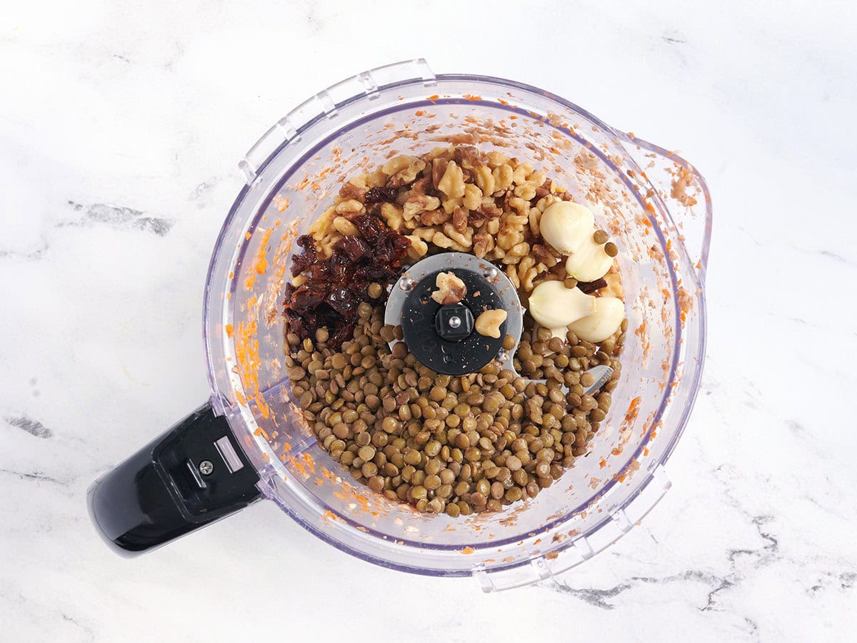 Garlic, lentils, walnuts, and sun dried tomatoes in a food processor.