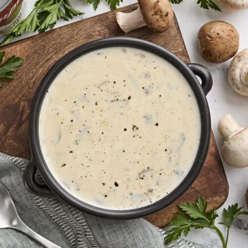 Overhead view of a bowl of cream of mushroom soup.