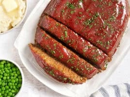 Overhead view of of a vegetarian lentil meatloaf with half cut into slices.