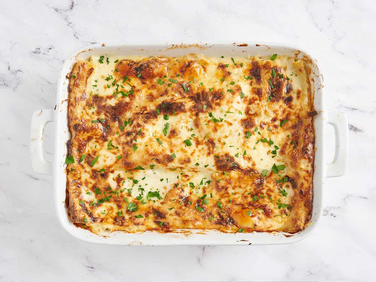 Finished seafood lasagna topped with parsley.