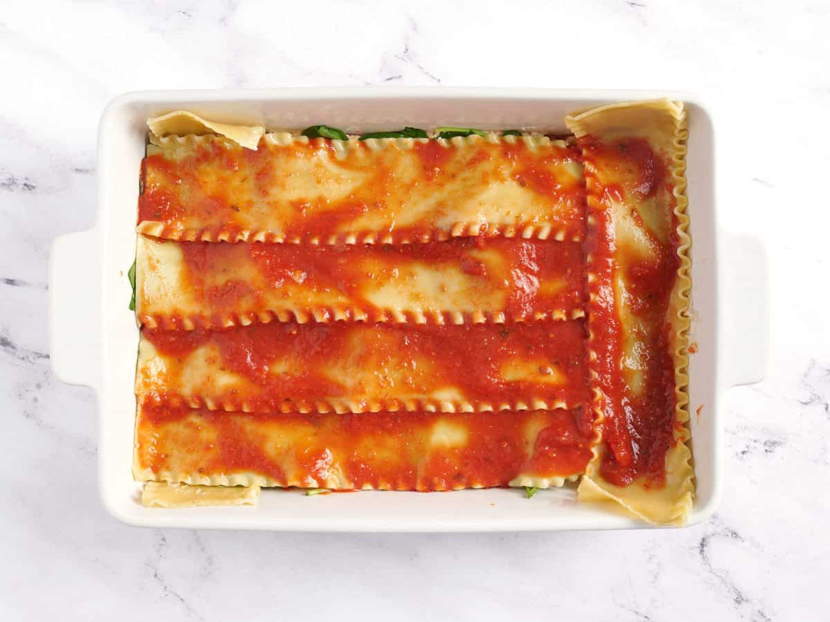 Marinara spread over noodles.