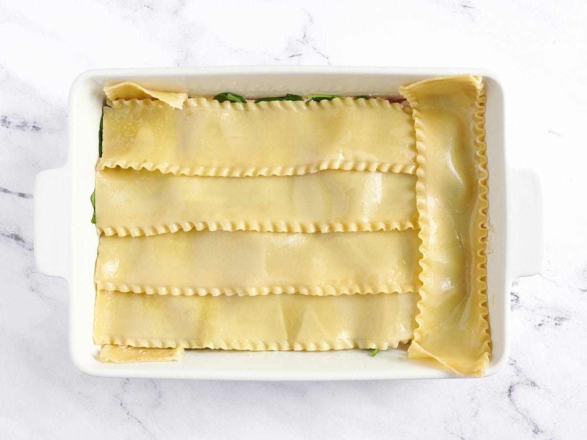 Lasagna noodles added to casserole dish.
