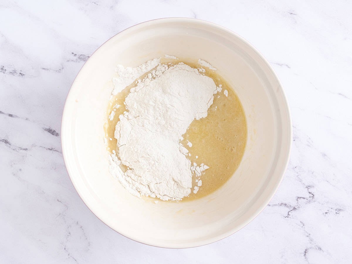 Adding flour to the wet mixture.