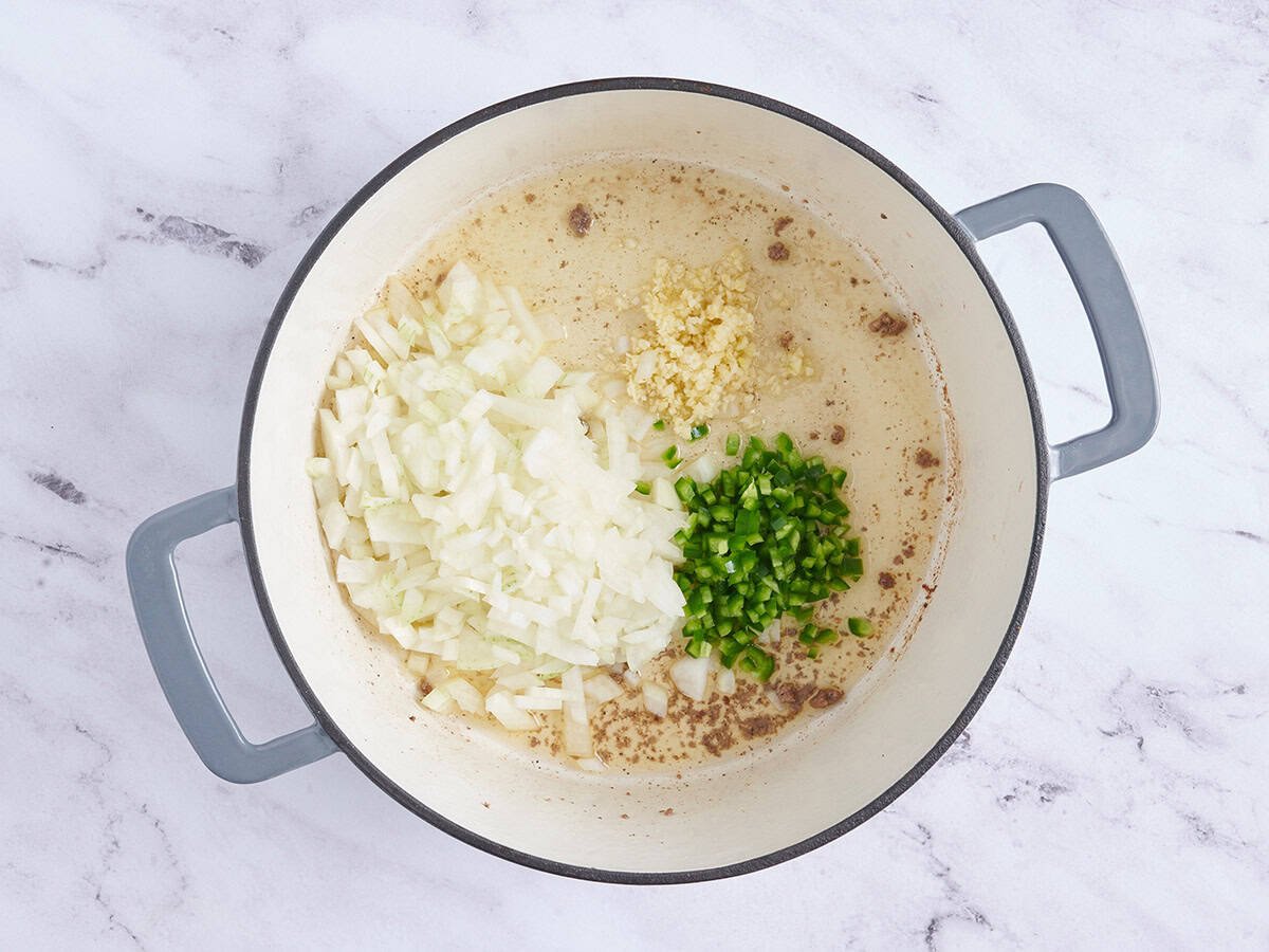 Onions, garlic and diced jalapeno in a pot.