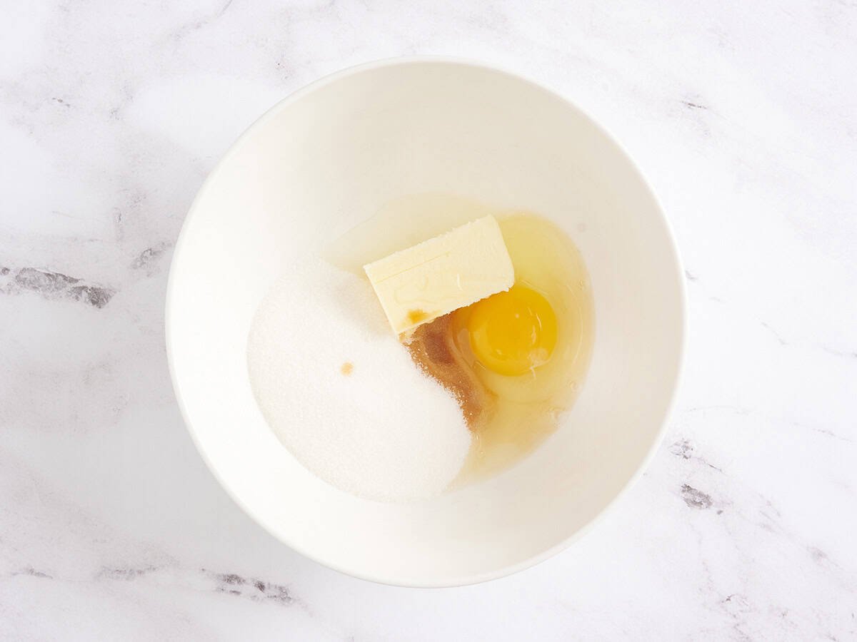 Egg, butter and sugar in a bowl.