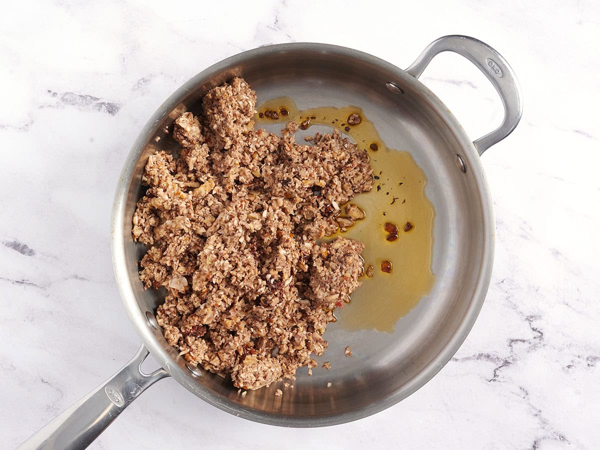 Lentil and vegetable mixture cooking in a sauce pan.