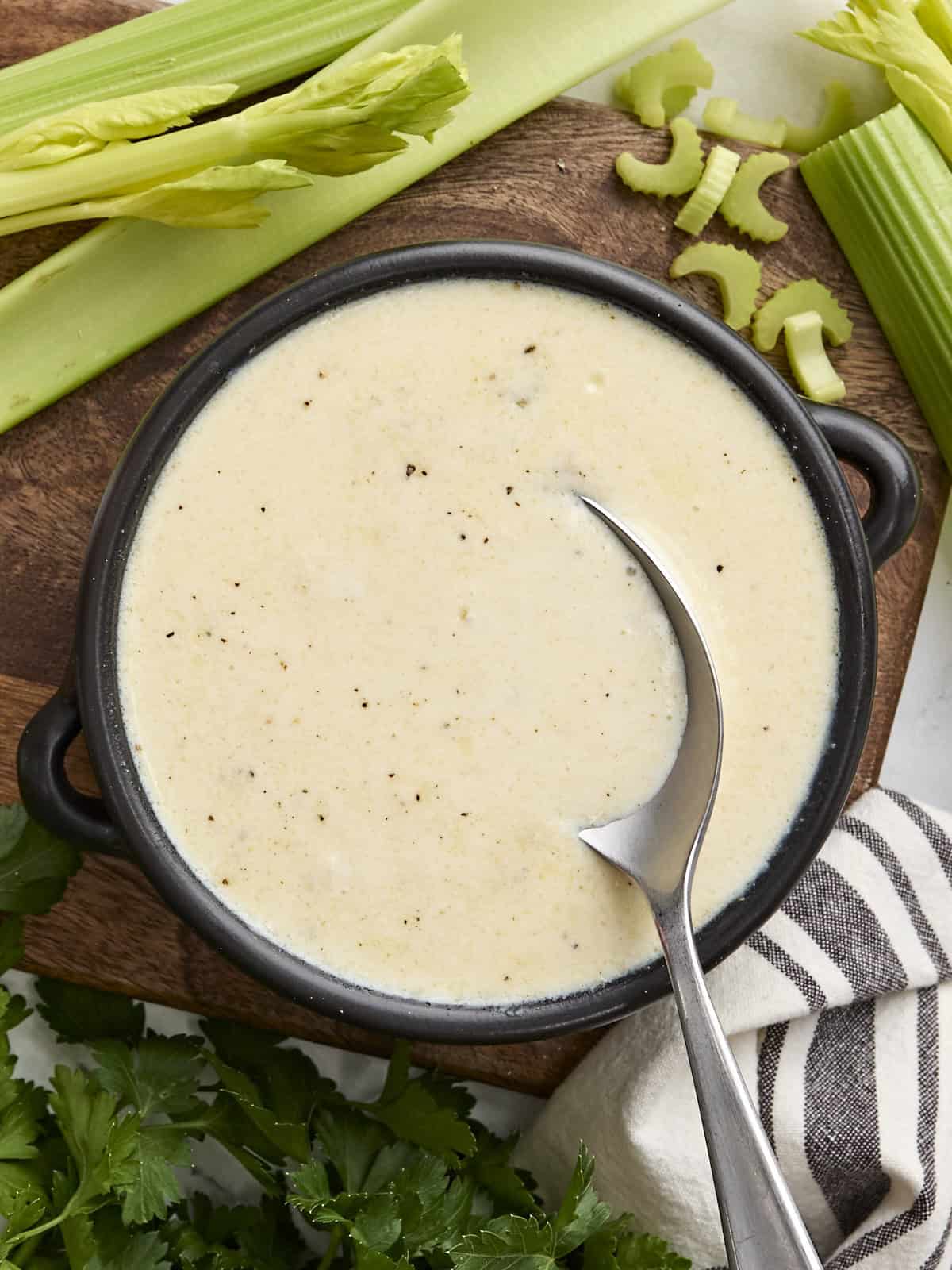 Overhead view of cream of celery soup with a spoon.
