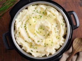 Overhead view of instant pot mashed potatoes topped with herbs.