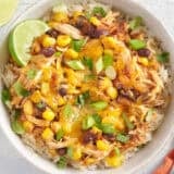 Overhead view of chicken bowls with tacos in a white bowl.