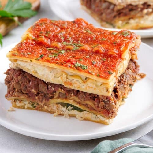 Side view of a slice of vegan lasagna on a plate.