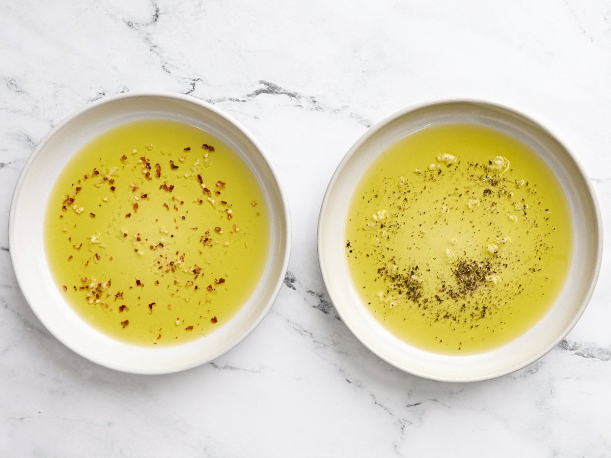 Adding seasonings to the olive oil and garlic mixture.