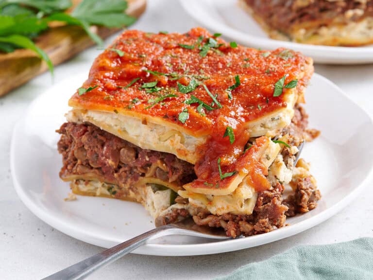 vegan lasagna being cut into with a fork