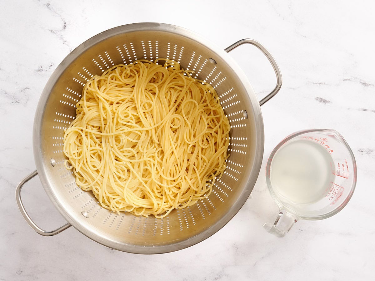 Cooked spaghetti in a colander.