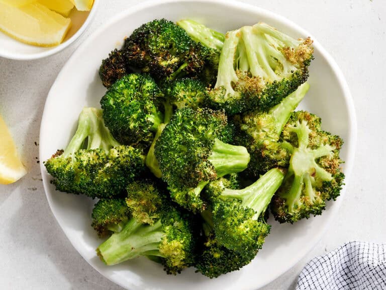 Overhead view of air fryer broccoli on a plate.