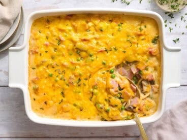 Overhead view of ham tetrazzini in a casserole dish with a spoon.
