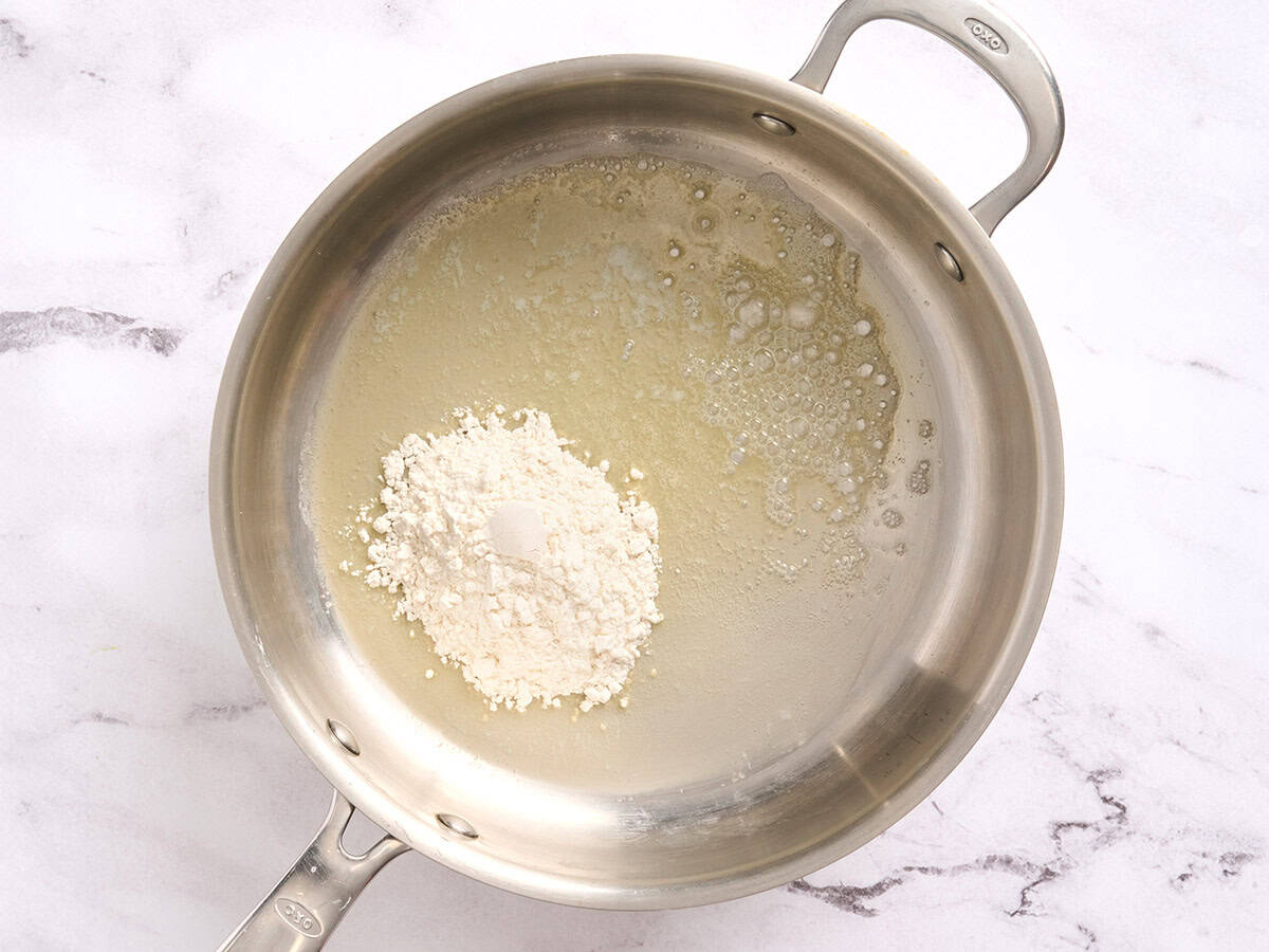 Flour added to melted butter in a skillet.