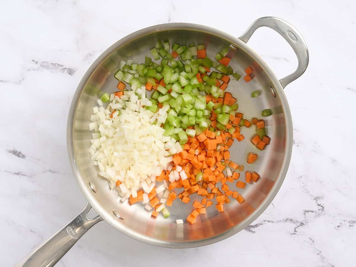 Diced celery, carrots and onion in a skillet with oil.