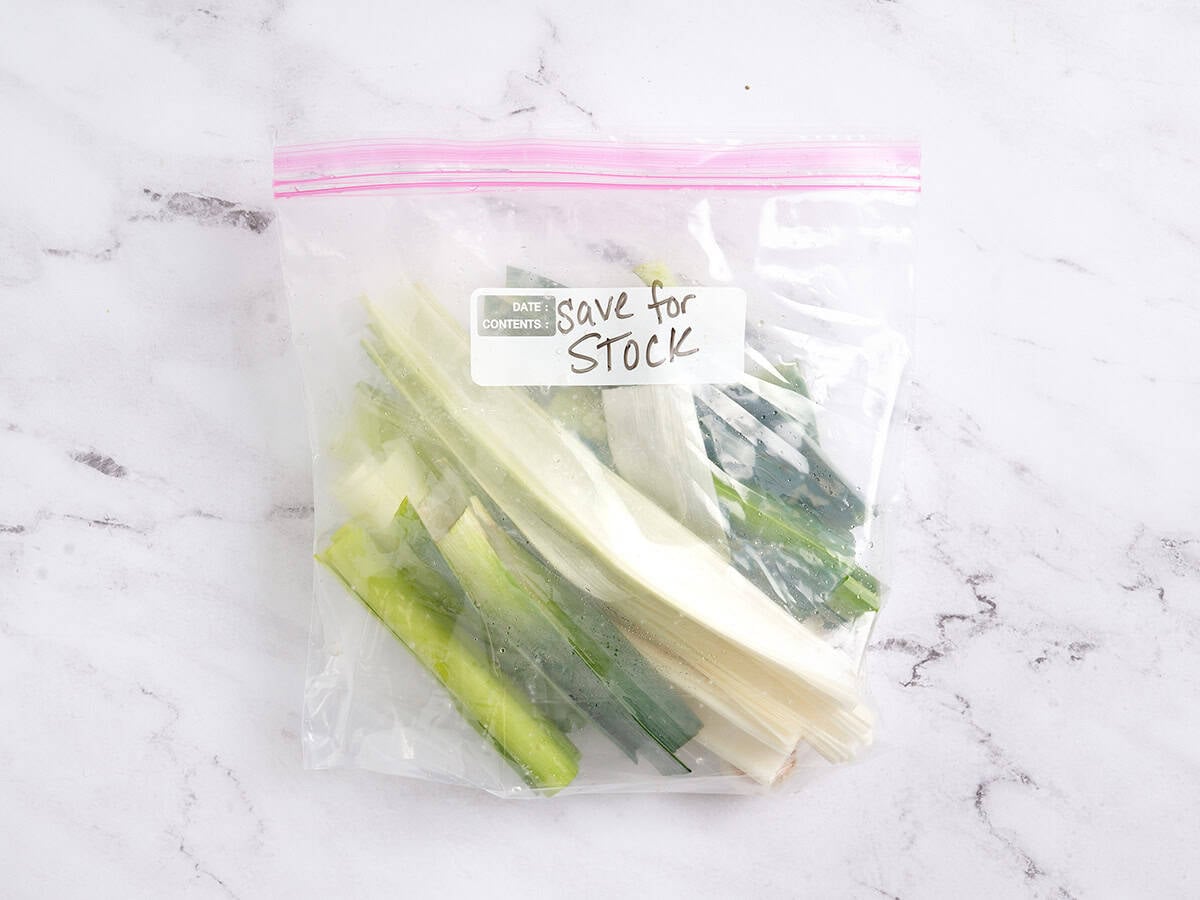 Trimmed leek leaves in a bag for storage.
