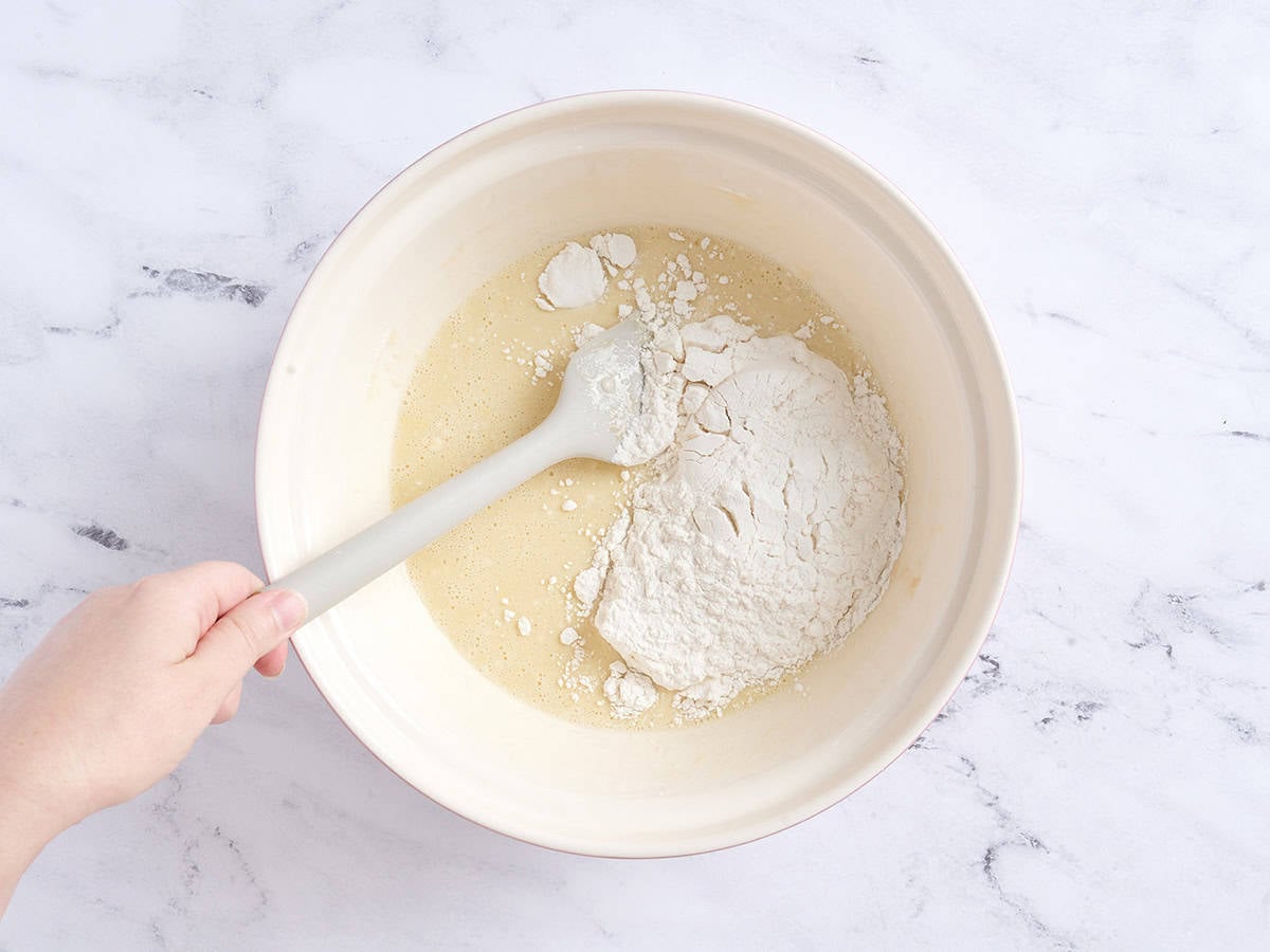 Incorporating the flour into the mixture.