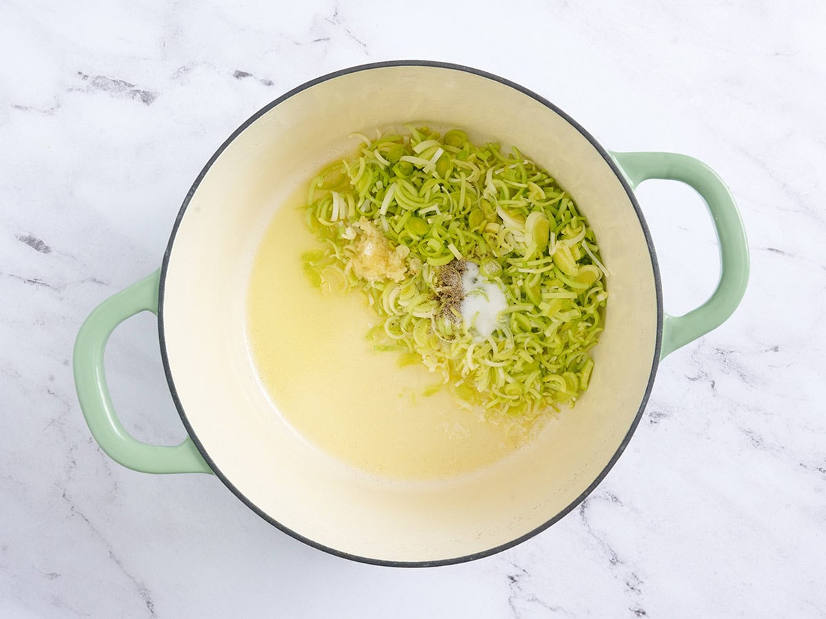 Melted butter and oil in a pot with minced leeks and garlic.