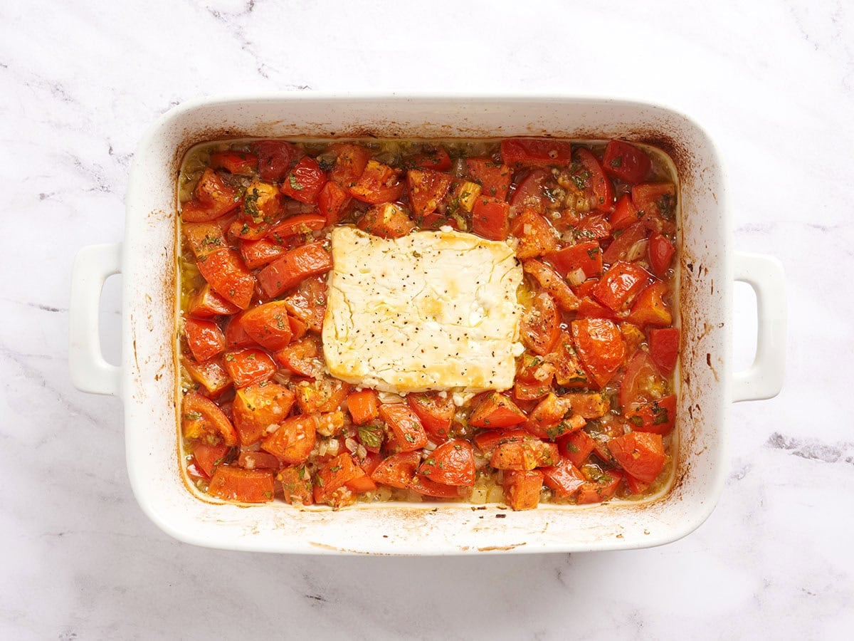 Baked feta and tomatoes in a baking dish.