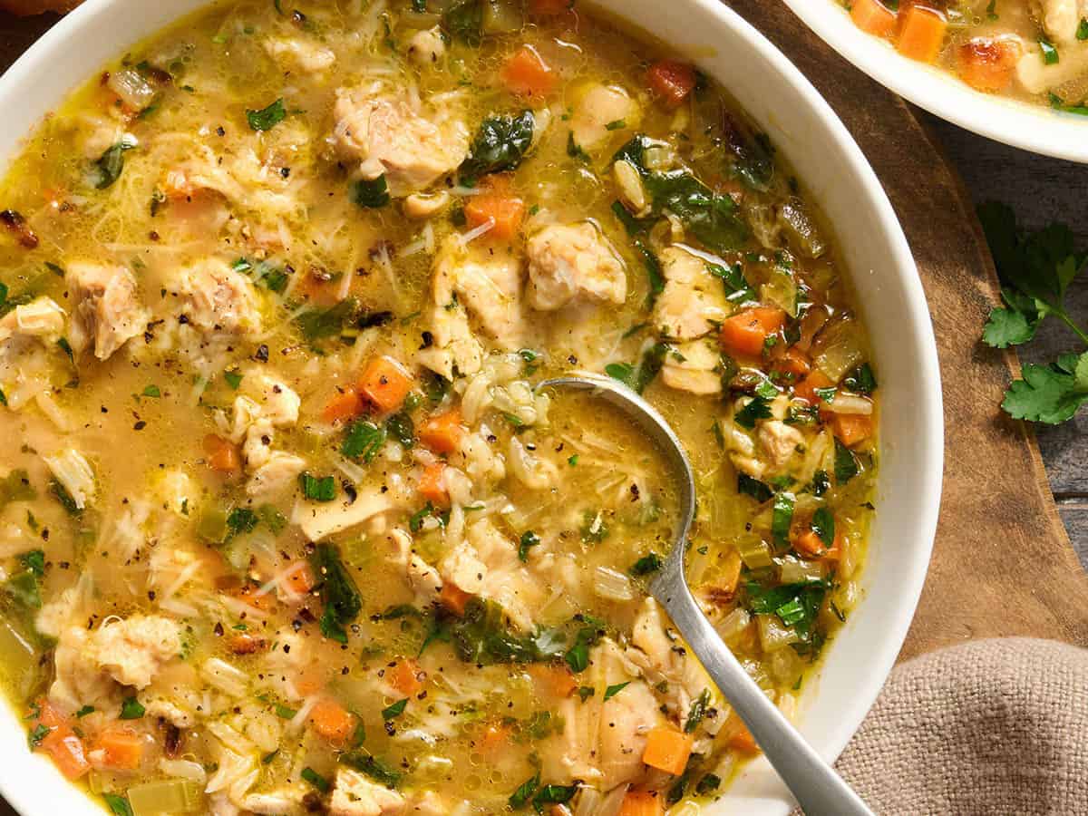 Overhead close up view of a chicken broth bowl.